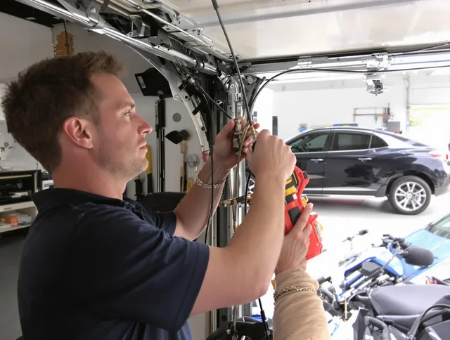 Parma Garage Door Repair safety certified technician performing cable replacement in Parma